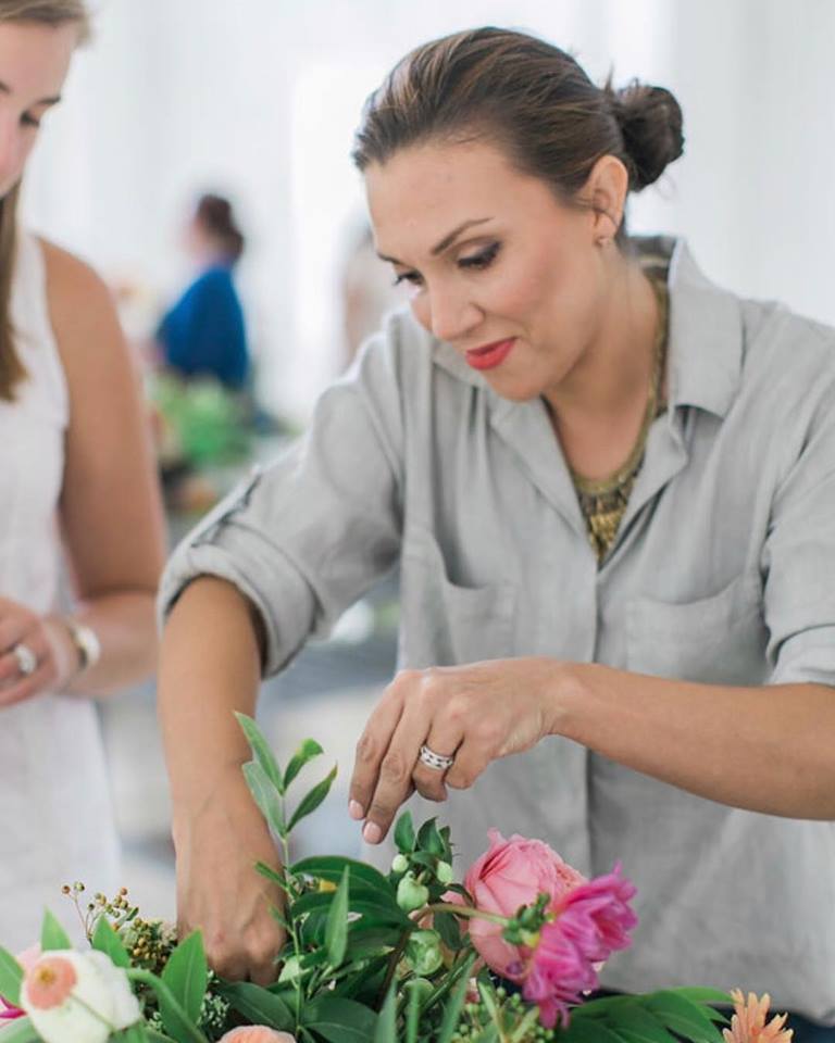 Maxine Owens works on a pink flower arrangement