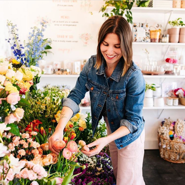 Natalie Gill arranging flowers in her California shop called Native Poppy