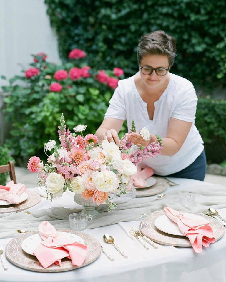 Laetitia Mayor works on a pink floral centerpiece
