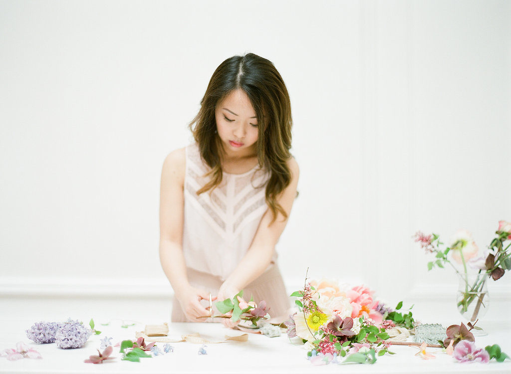 Heather Siu trims fresh flowers as she designs a floral arrangement