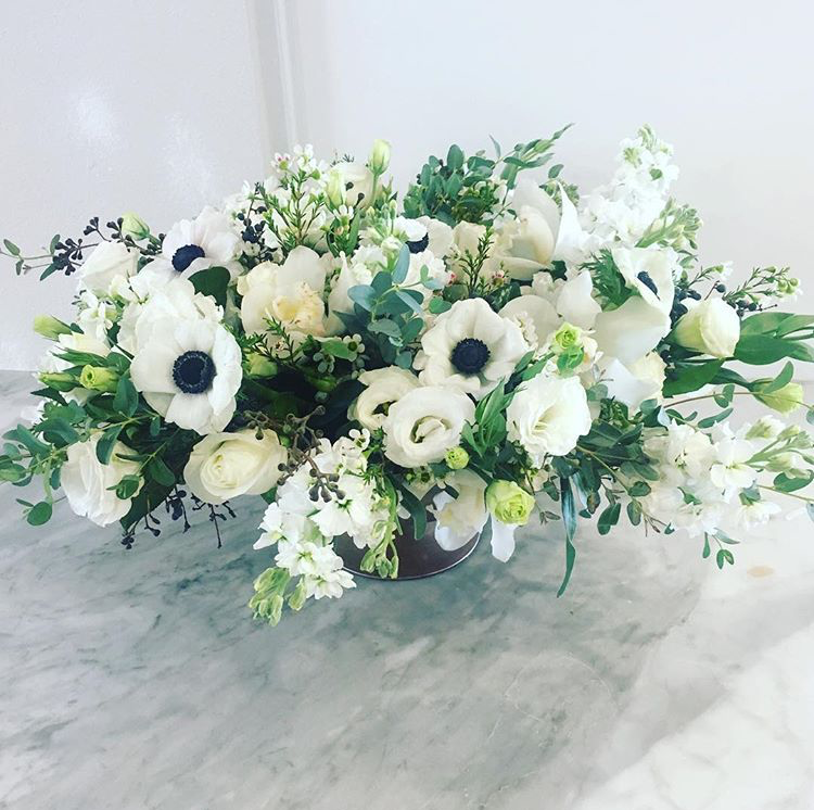 A large white and green fresh flower arrangement by Morgan Anderson