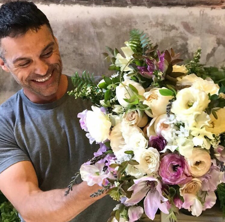 Max Gill holding a flower arrangement