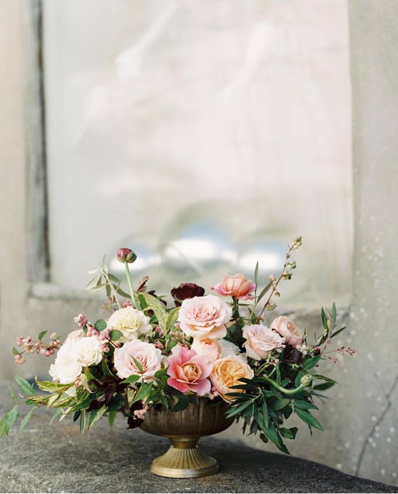 a floral arrangement in a bronze vase by Meg Connelly