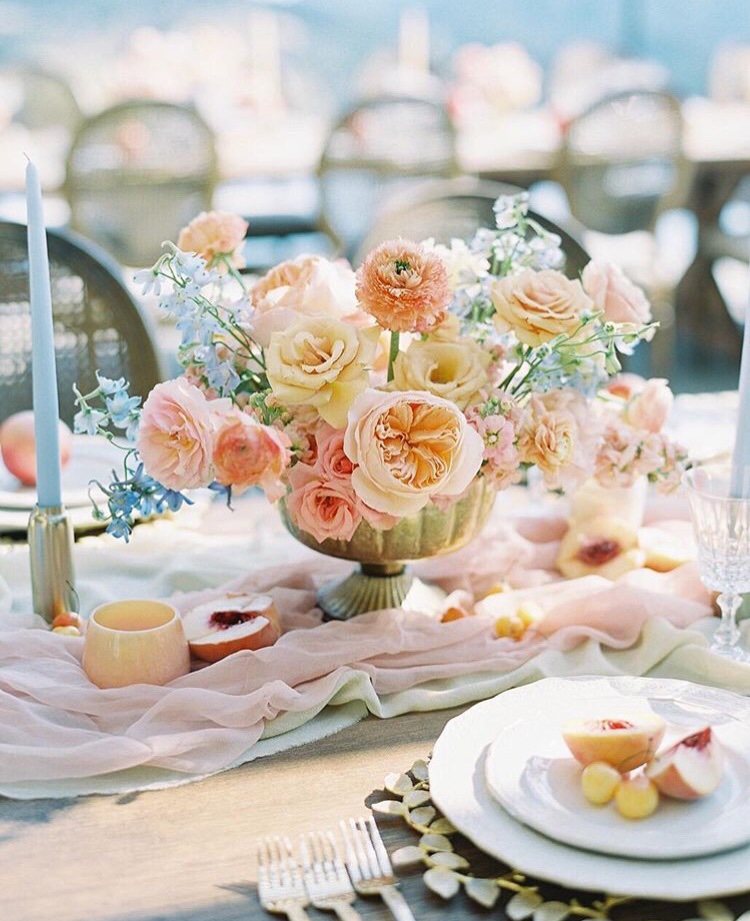A pink and yellow floral centerpiece by Janelle Wylie, owner of Lavenders Flowers & Tono + Co