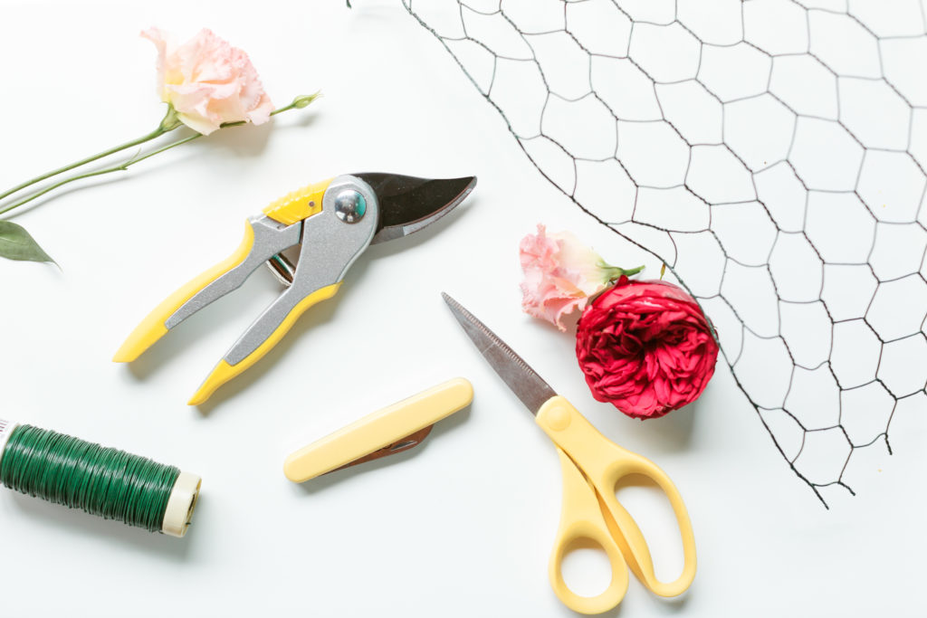 A flatlay of floral design tools and flowers at Mayesh Design Star Workshop