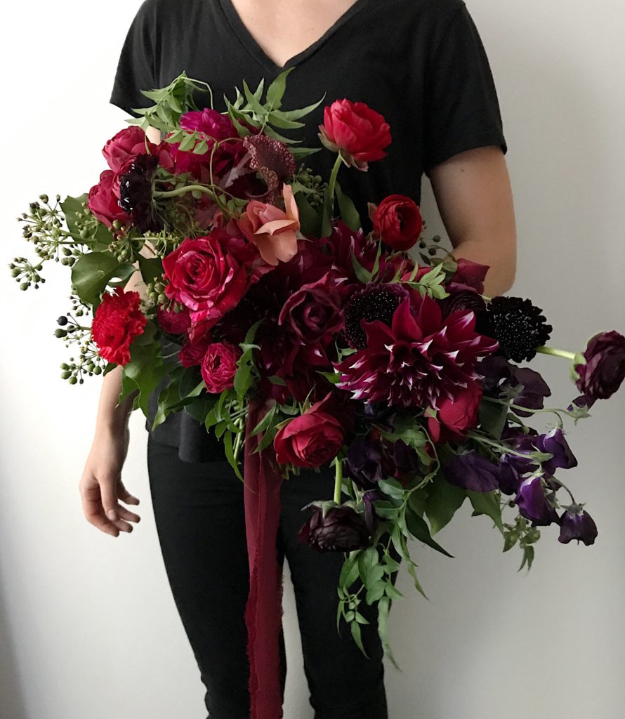 A dark red and maroon floral arrangement by Cara Fitch