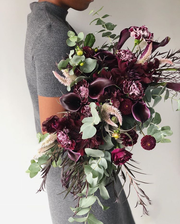 A burgundy and pink floral arrangement by Teresa Fung