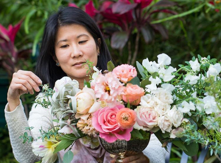Teresa Fung works on a floral arrangement