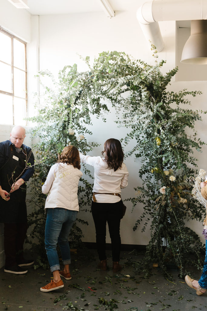 Attendees work on a floral arch at the Mayesh Design Star Workshop