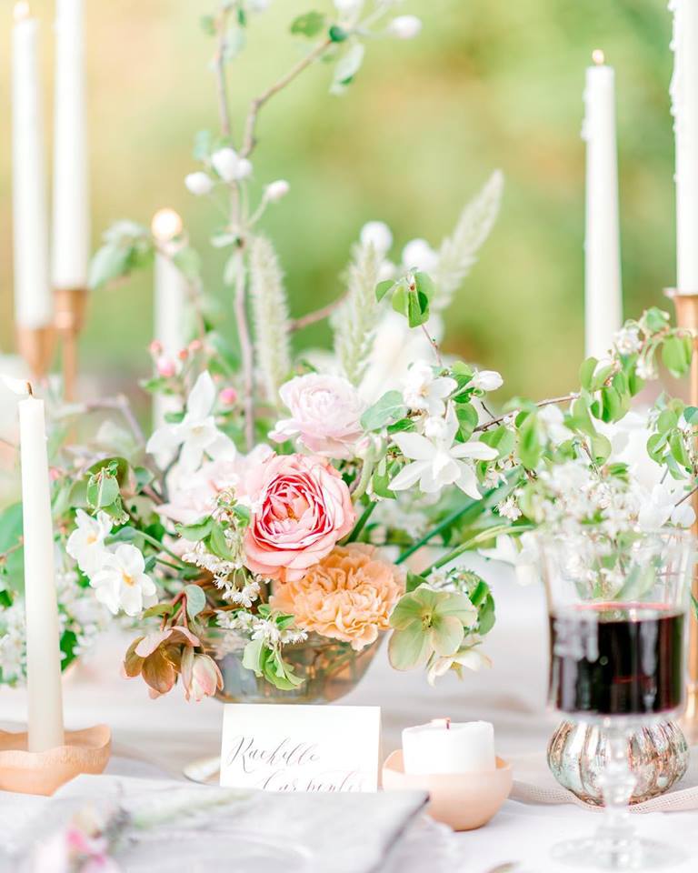 a floral centerpiece with a pink rose by Jennifer Haf