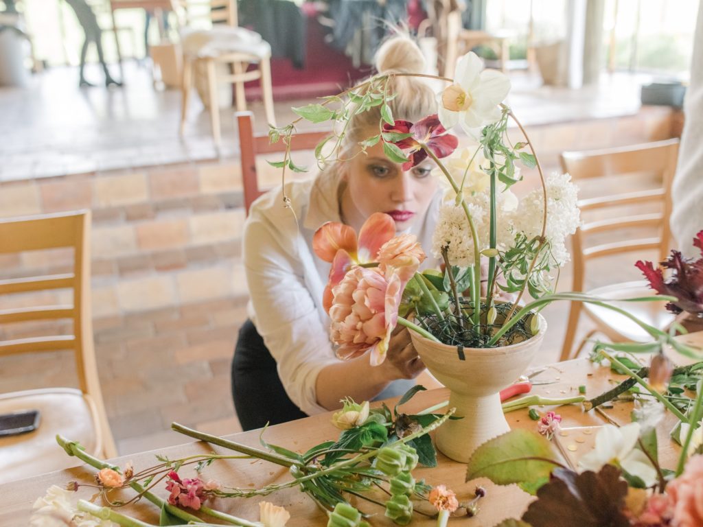 A student works on a floral arrangement at one of NYBG's summer intensives