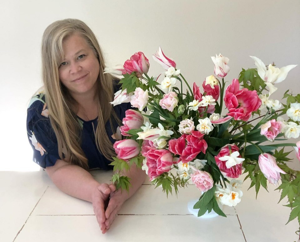 Alicia Schwede with a pink and white floral arrangement