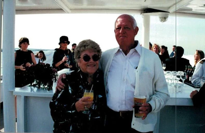 Ali Dahlson's grandparents hold their drinks at a celebratory party