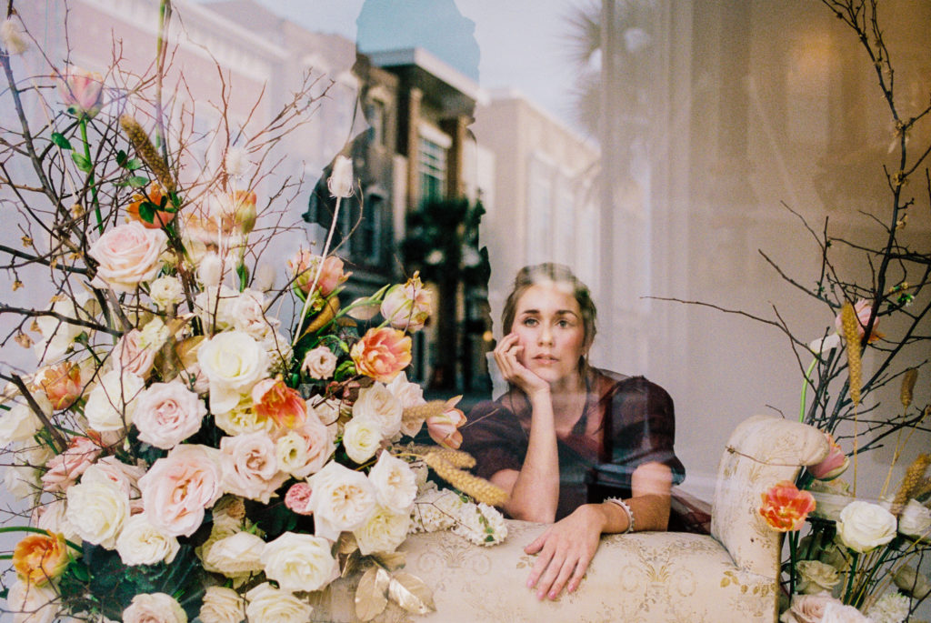 Charleston model and floral installation by On a Limb in storefront