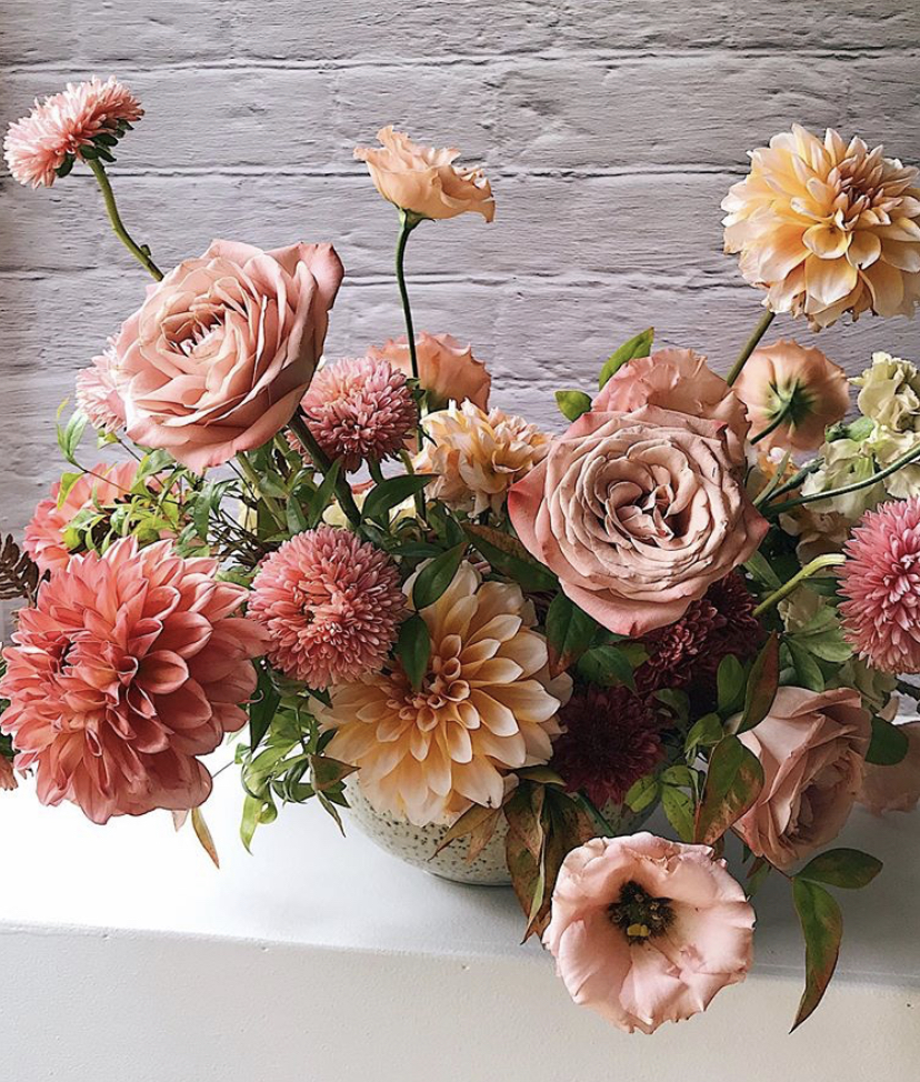 floral arrangement of roses and dahlias in shades of salmon