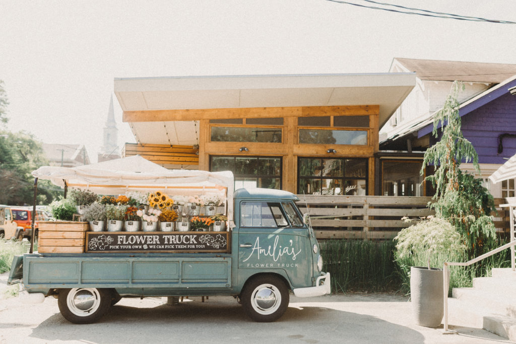Amelia's green flower truck parked in front of a Nashville business