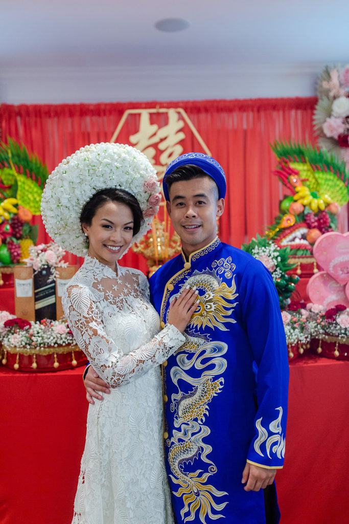 bride and groom in front of the tea ceremony altar during the Vietnamese wedding tradition