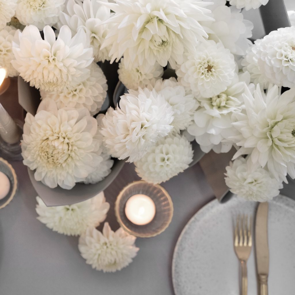 White dahlia and candleight tablescape as seen from above