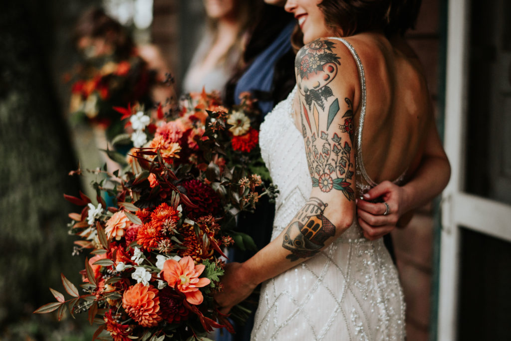 bride holding autumn bouquet of local flowers