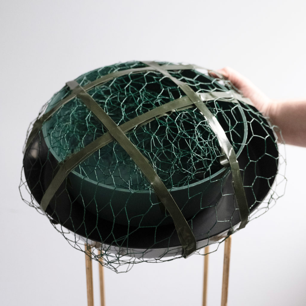 sustainable floral design technique using chicken wire in a round bowl secured with waterproof tape