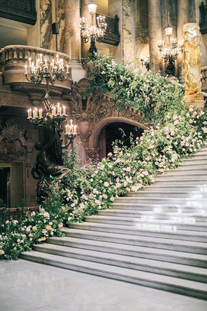 Opera Garnier grans staircase lined with greenery and pink flowers by Floraison Paris