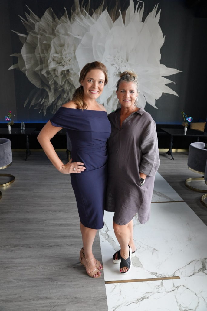 Corrine Heck, CEO of Details Flowers standing with Design Associate Parie Donaldson