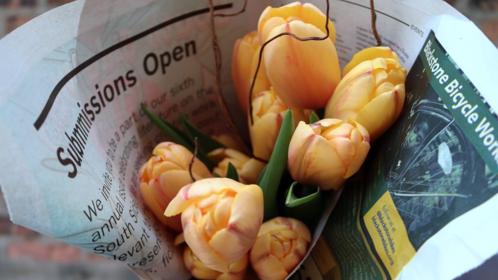 Yellow tulips grown by Southside Blooms wrapped in newspaper 