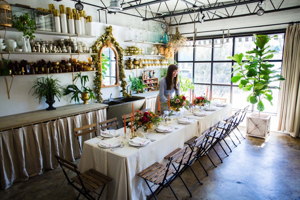 Sarah Shell, owner of Fern Studio Flowers, working on a tablescape for an event in her flower shop