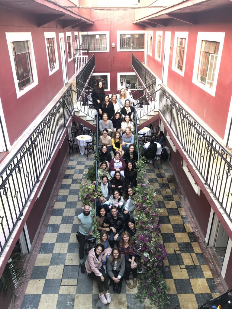 floral designer team sitting on a staircase at Flower House Mexico