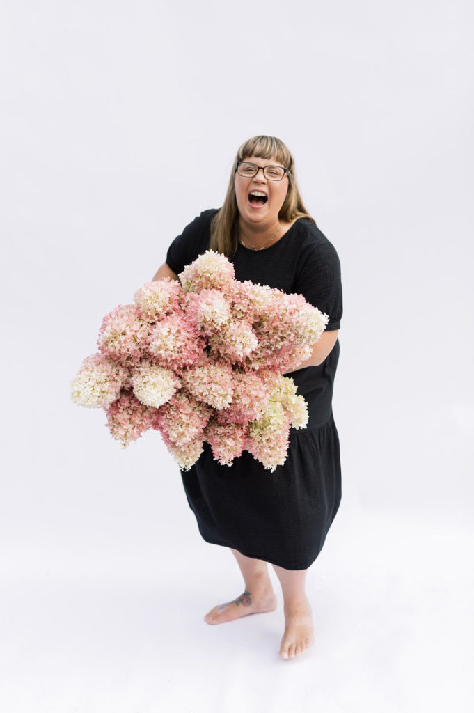 Living Fresh owner Tina Sharpe holds an armful of pink hydrangeas