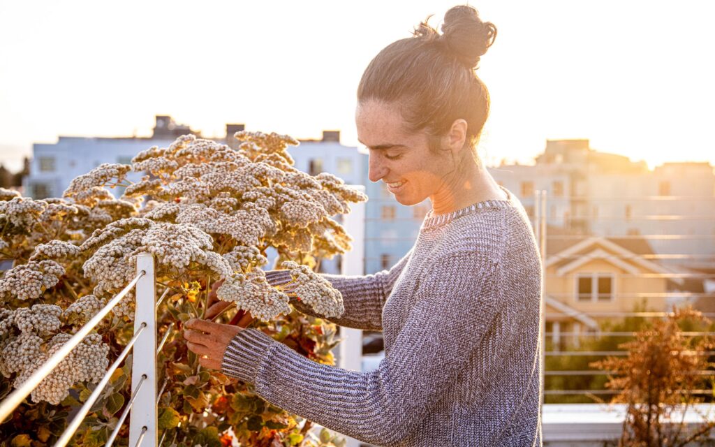 Joanna Letz harvesting flowers at her rooftop farming space in Berkeley California