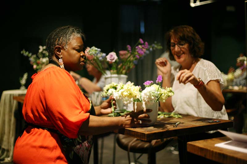 Marsha Parker arranging flowers with a student at a Contend for Peace Workshop for cancer survivors