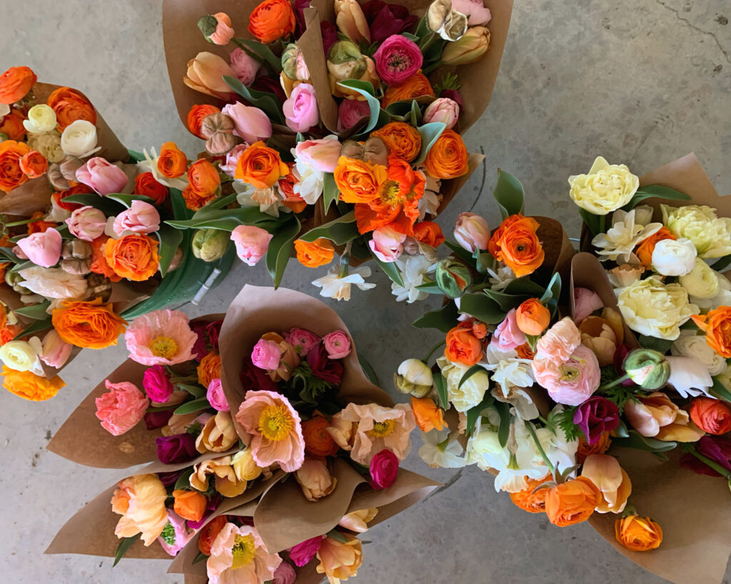 bouquets of brightly colored flowers wrapped in kraft paper and grown by flower farming expert Lennie Larkin of B-Side Farm