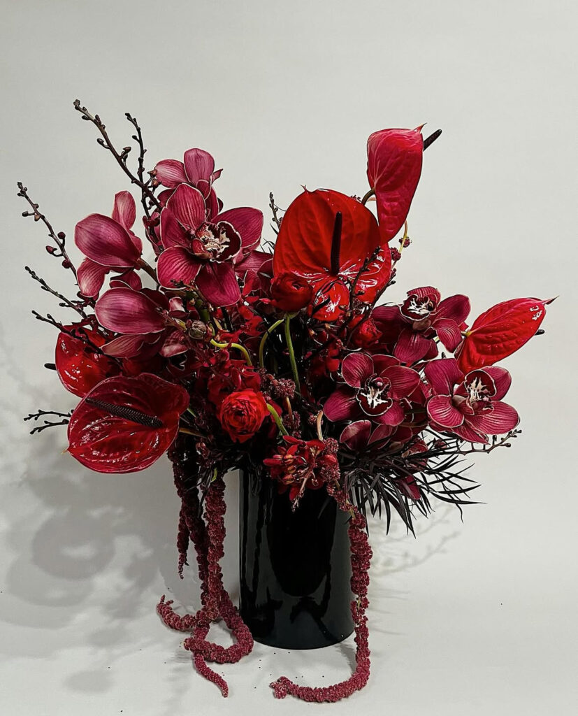 Olivee Floral Valentine's Day arrangement of red flowers in a black vase 